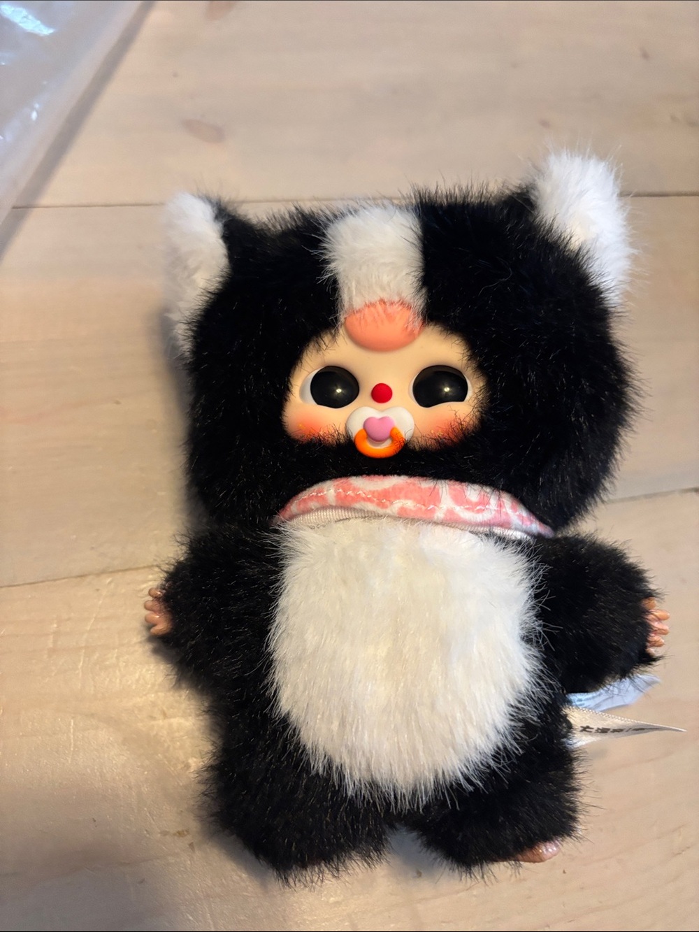 Black & White Plush Baby Doll with Pink Pacifier and Scarf
